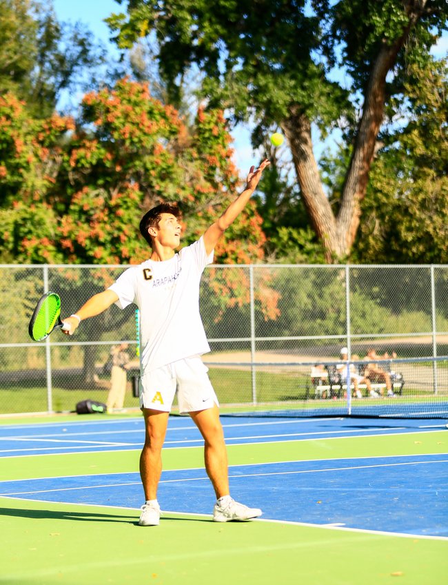 Arapahoe's Tyler Rock starts the point with his serve in his No. 2 singles match against Rocky Mountain's Braden Peterson Sept. 28 at deKoevend Park. Rock won the match in straight sets, and the Warriors advanced to the second round of the state 5A team tennis tournament by a score of 4-3 over Rocky Mountain.